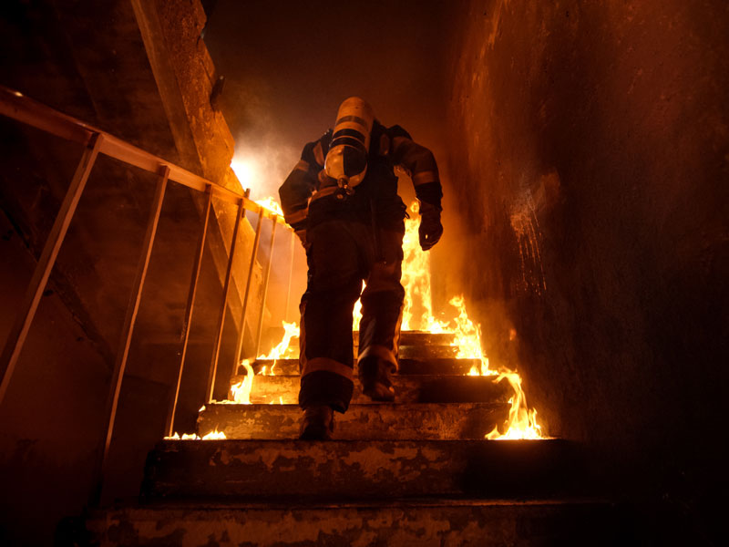 Fire fighter climbing stairs